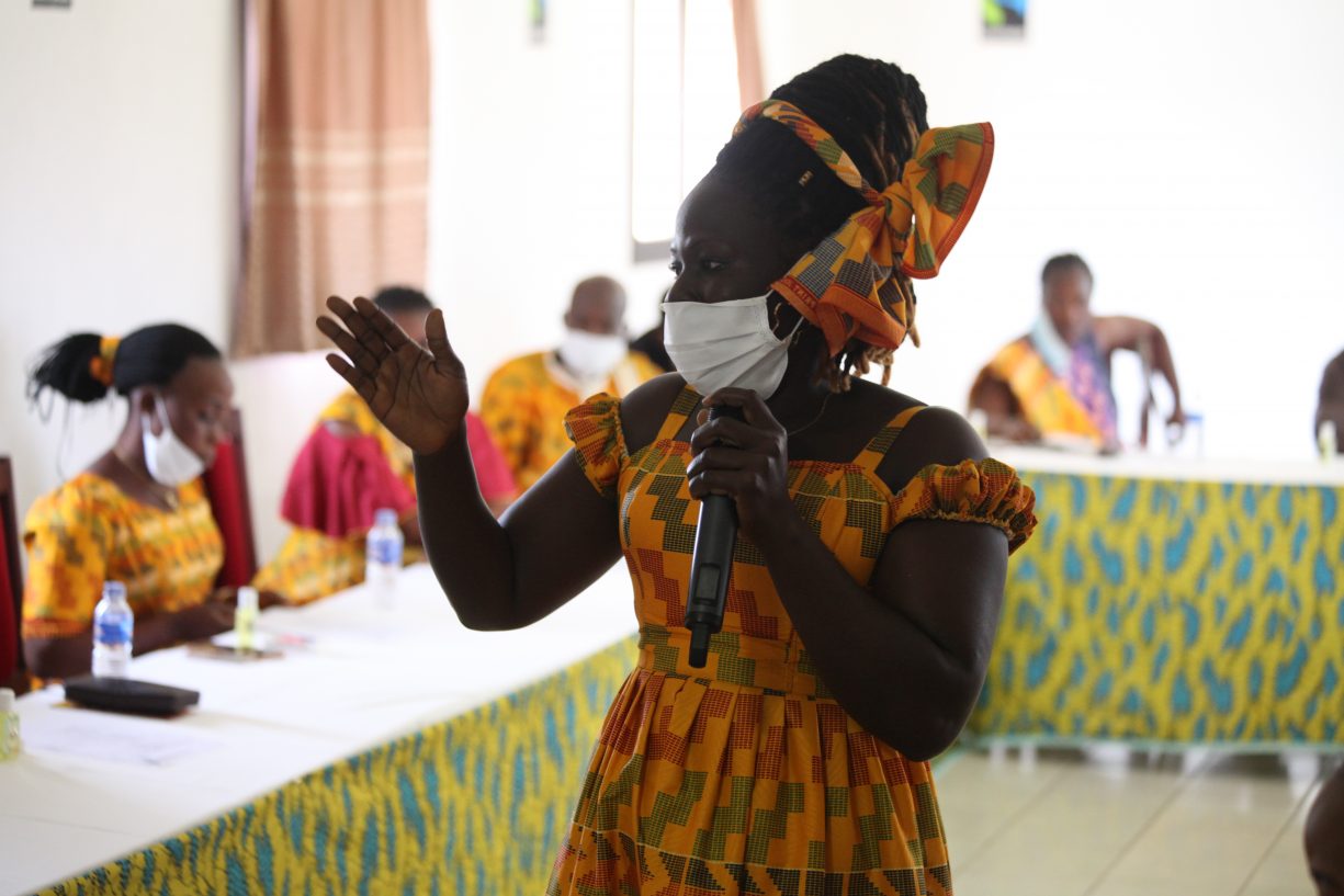 Woman wearing mask speaks to the 2020 graduating class of the Women's Leadership School in Cote d'Ivoire.