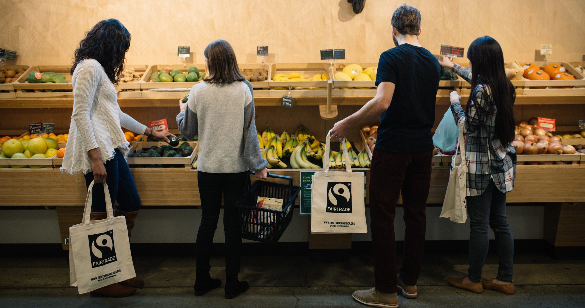 Four people shopping in the produce section at an organic market in Washington, DC.