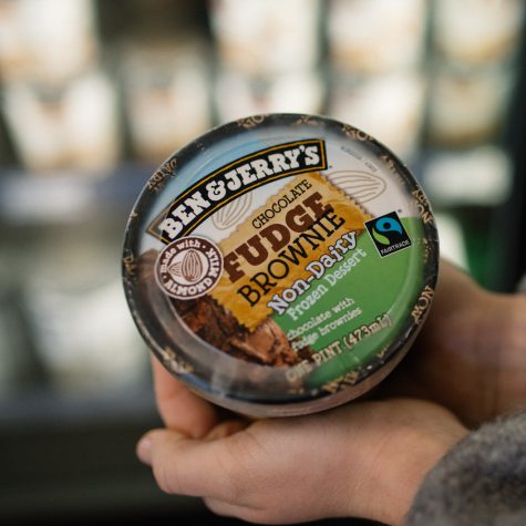 Shopper holds Ben & Jerry's non-dairy ice cream pint in an organic market.