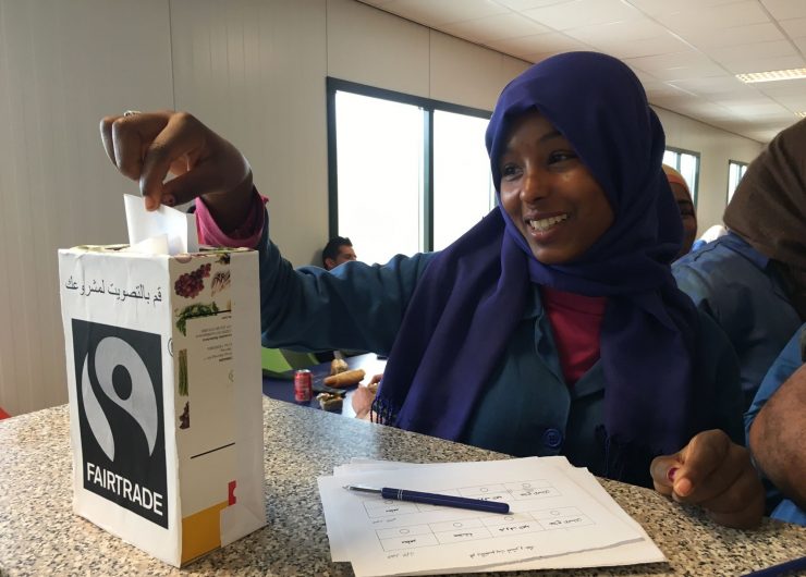 Woman in Tunisia voting on Fairtrade Premium project.