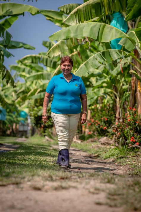 Yadira, a banana grower in Colombia, walks through her Fairtrade certified farm.