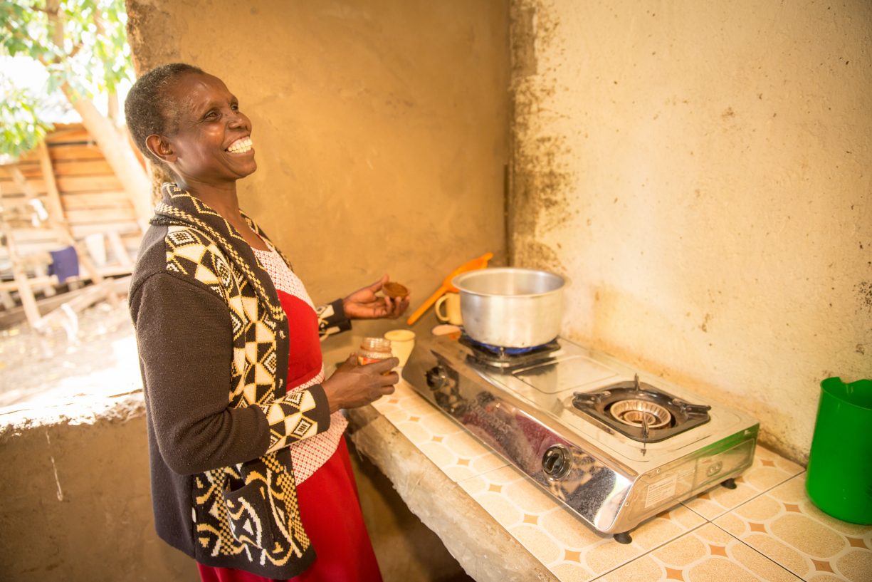 Woman using biogas cook stove no longer needs to use firewood for daily cooking needs.