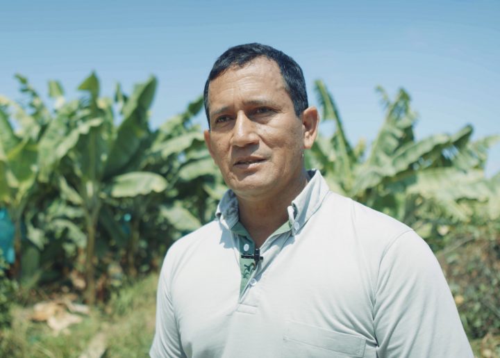 Fairtrade certified banana farmer in front of banana trees in Peru