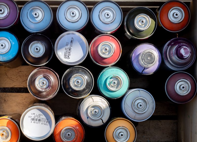 Cans of paint used by Austin Muralist, J Muzacz