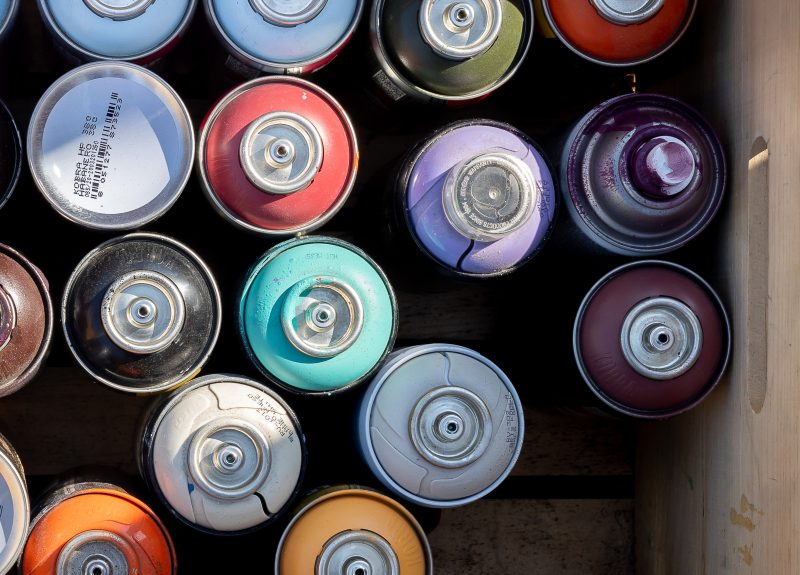 Cans of paint used by Austin Muralist, J Muzacz