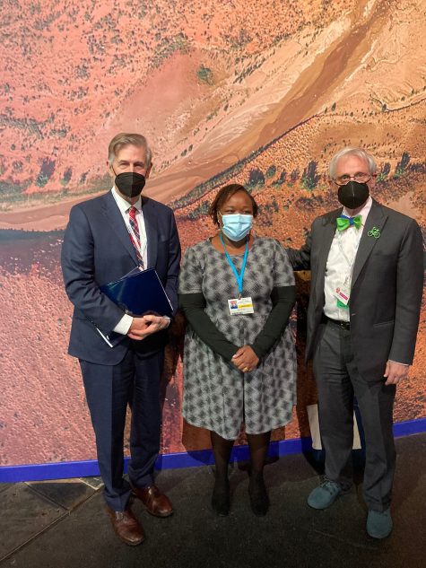 Mary Kinyua from Fairtrade Africa stands with Congressmen Beyer and Blumenauer at COP26.