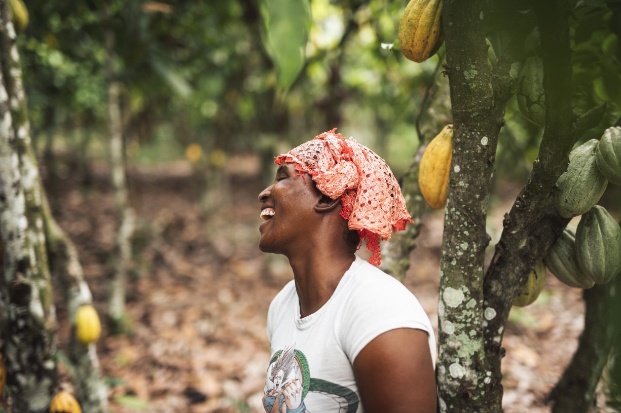 Dah Oho, cocoa farmer, laughing in cacao forest