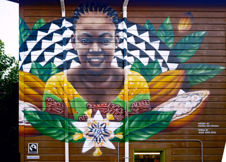 Vibrant mural of Deborah Osei-Mensah depicting cocoa pods and flowers. This mural can be found at the People's Food Co-op in Portland, Oregon.