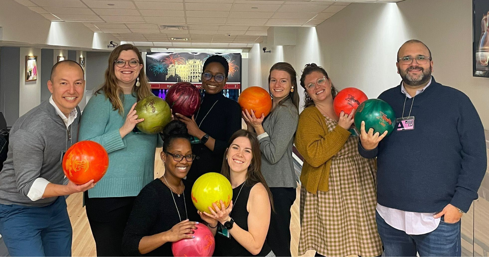 Photo of Fairtrade America 2022, two men and six women team holding bowling balls