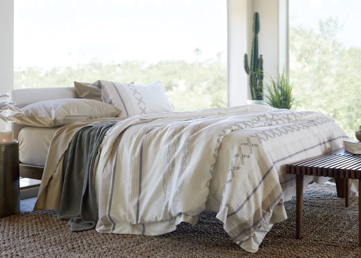 A scenic bedroom with Earth-toned bedding linens.