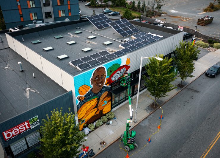 A drone shot of the mural of cocoa farmer Bengaly Bourama on the side of Urban Greens Co-op Market in Providence, Rhode Island.