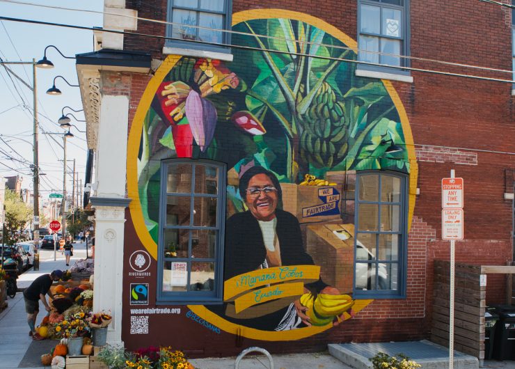 Mural of Ecuadorian banana farmer, Mariana Cobos, painted by Betsy Casañas on the side of Riverwards Produce in Philadelphia, PA.