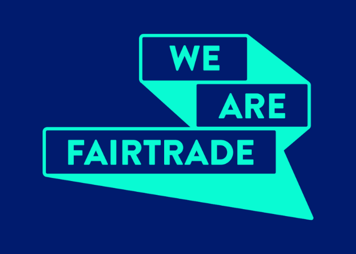 We Are Fairtrade logo in tan on a blue background.