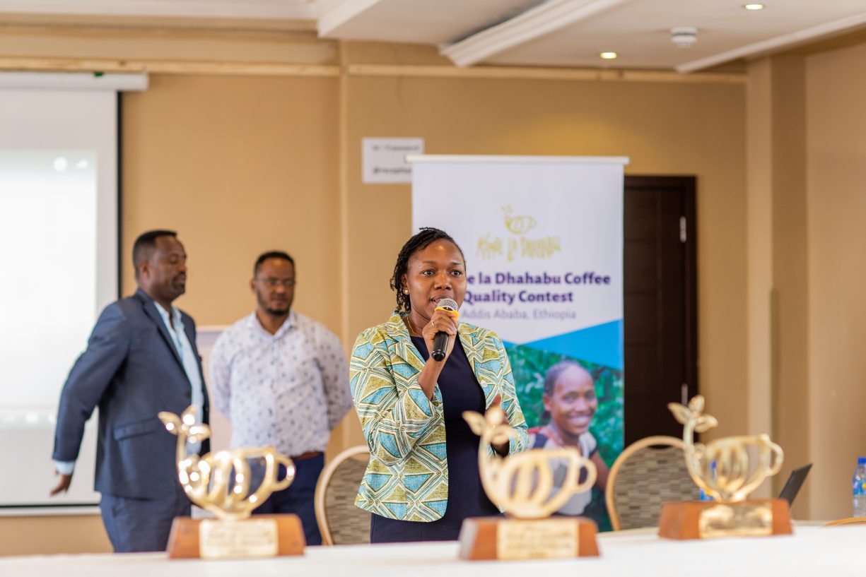 Faith Muthoni speaks to a group at a Golden Cup Fairtrade coffee event.